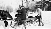 Benton MacKaye mounting horse-drawn sleigh in Shirley Center, MA