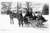 Benton MacKaye driving horse-drawn sleigh on Center Rd in Shirley Center, MA